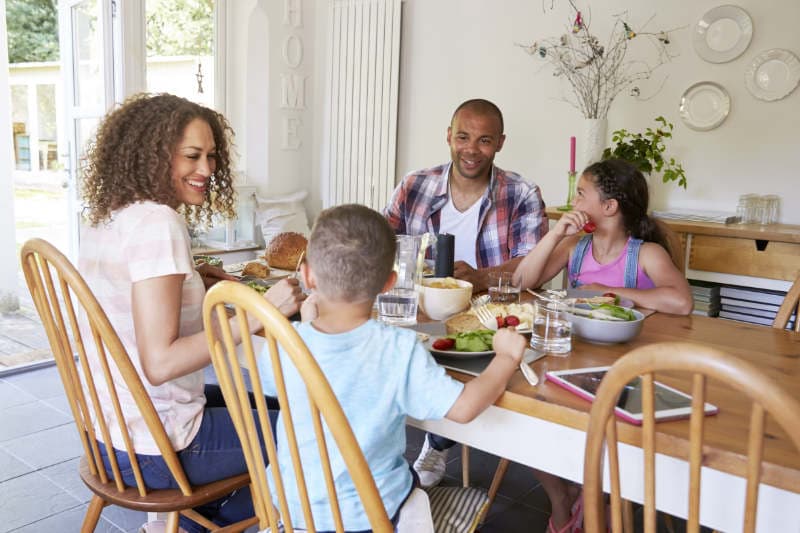 Ethnic family sitting around the dinner table.