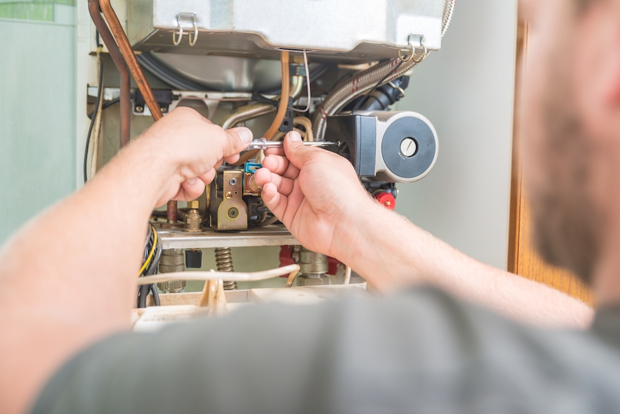 Technician repairing Gas Furnace.