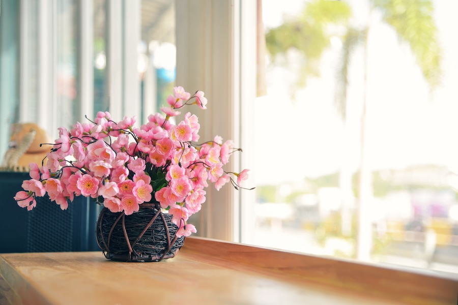 Beautiful flowers in vase with light from window.