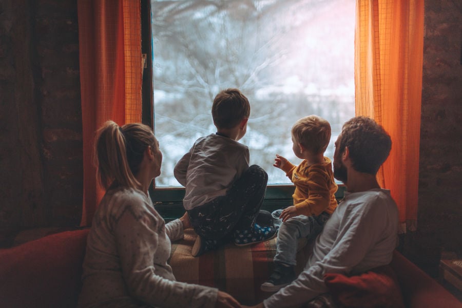 Family looking out the window in the family room.