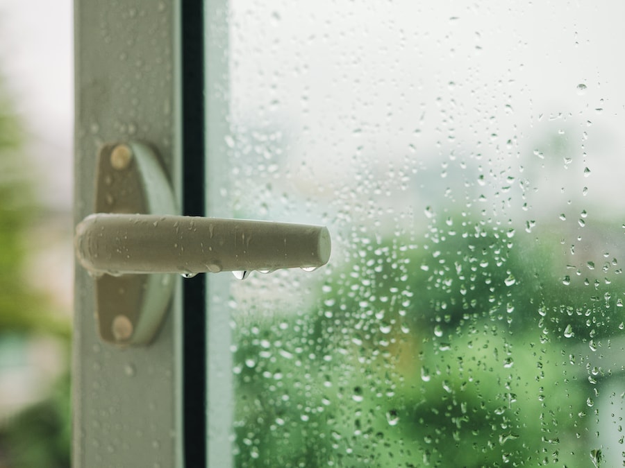 Raindrop on window with Handle Blur tree background Rainy Season.