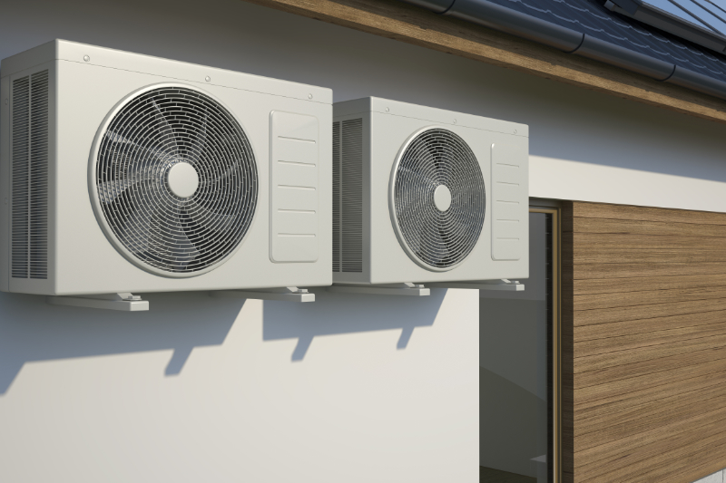 air conditioners sitting on the outside of a building.