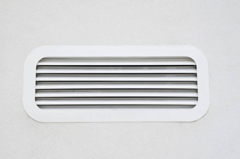 New white air scrubber vent on wall closeup in Weiser