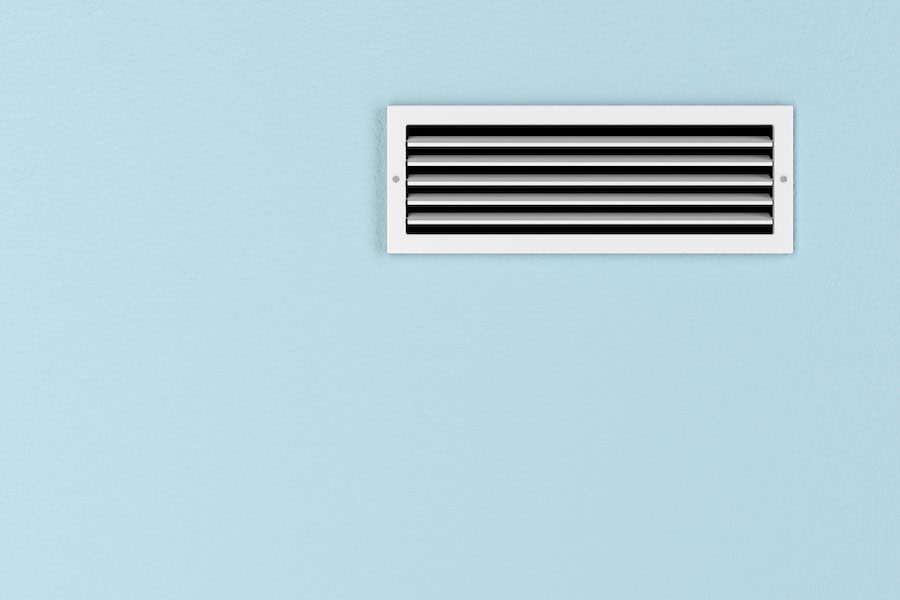 Air conditioning vent on the blue wall.
