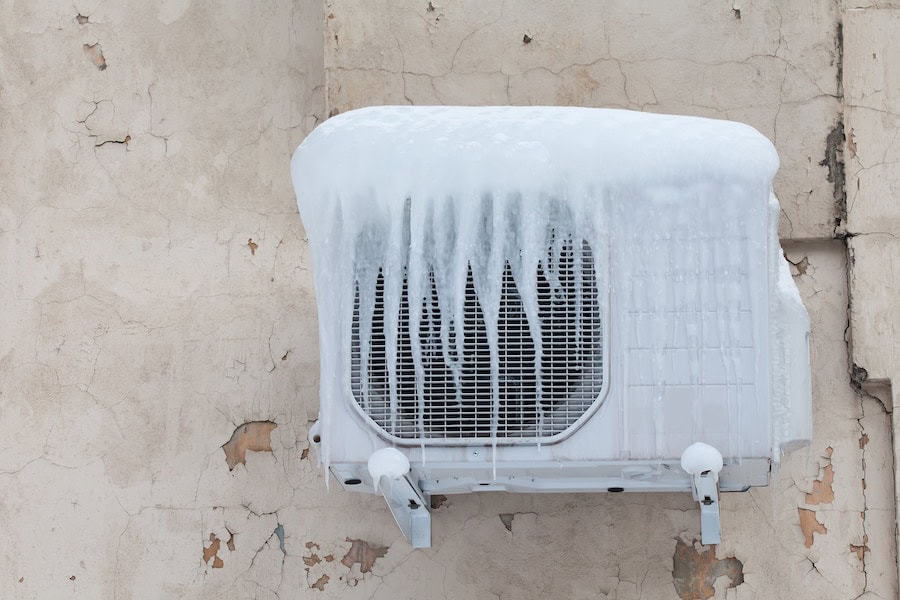Air conditioner with frozen ice and icicles. Cooling