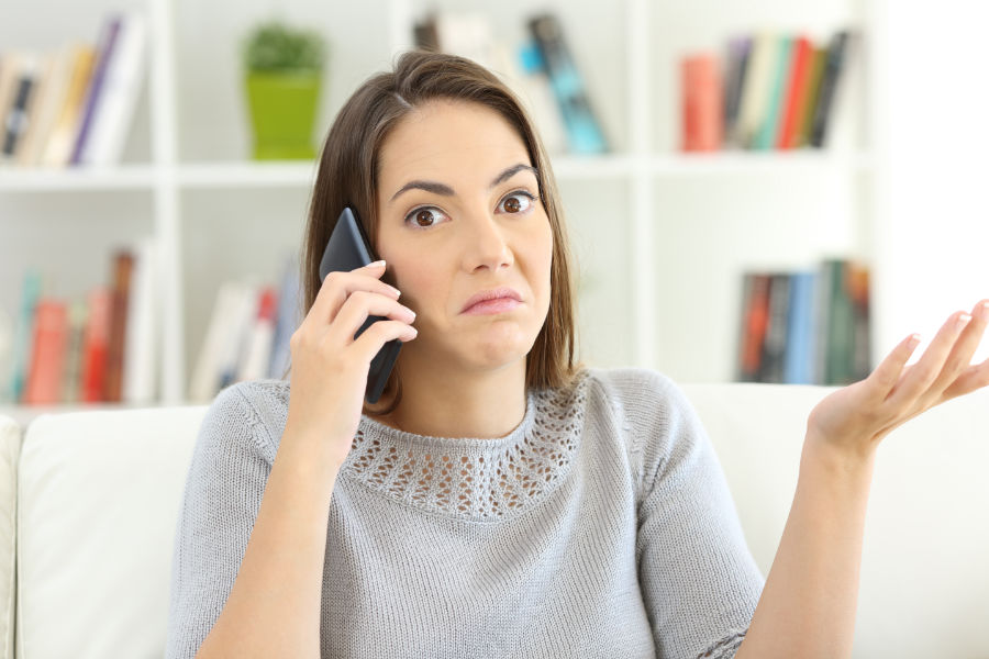 Confused woman on the phone.|